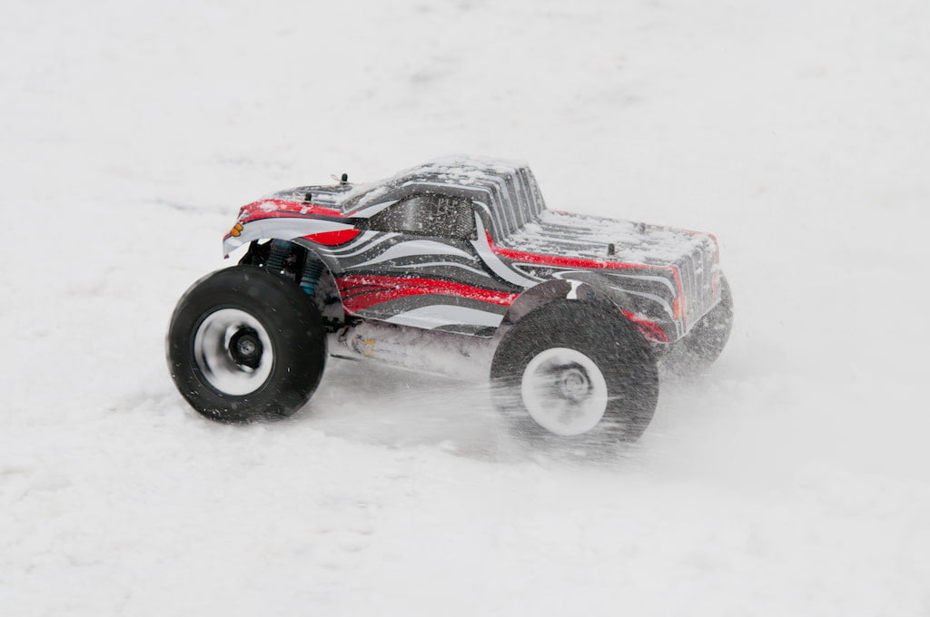 closeup of rc truck driving in the snow