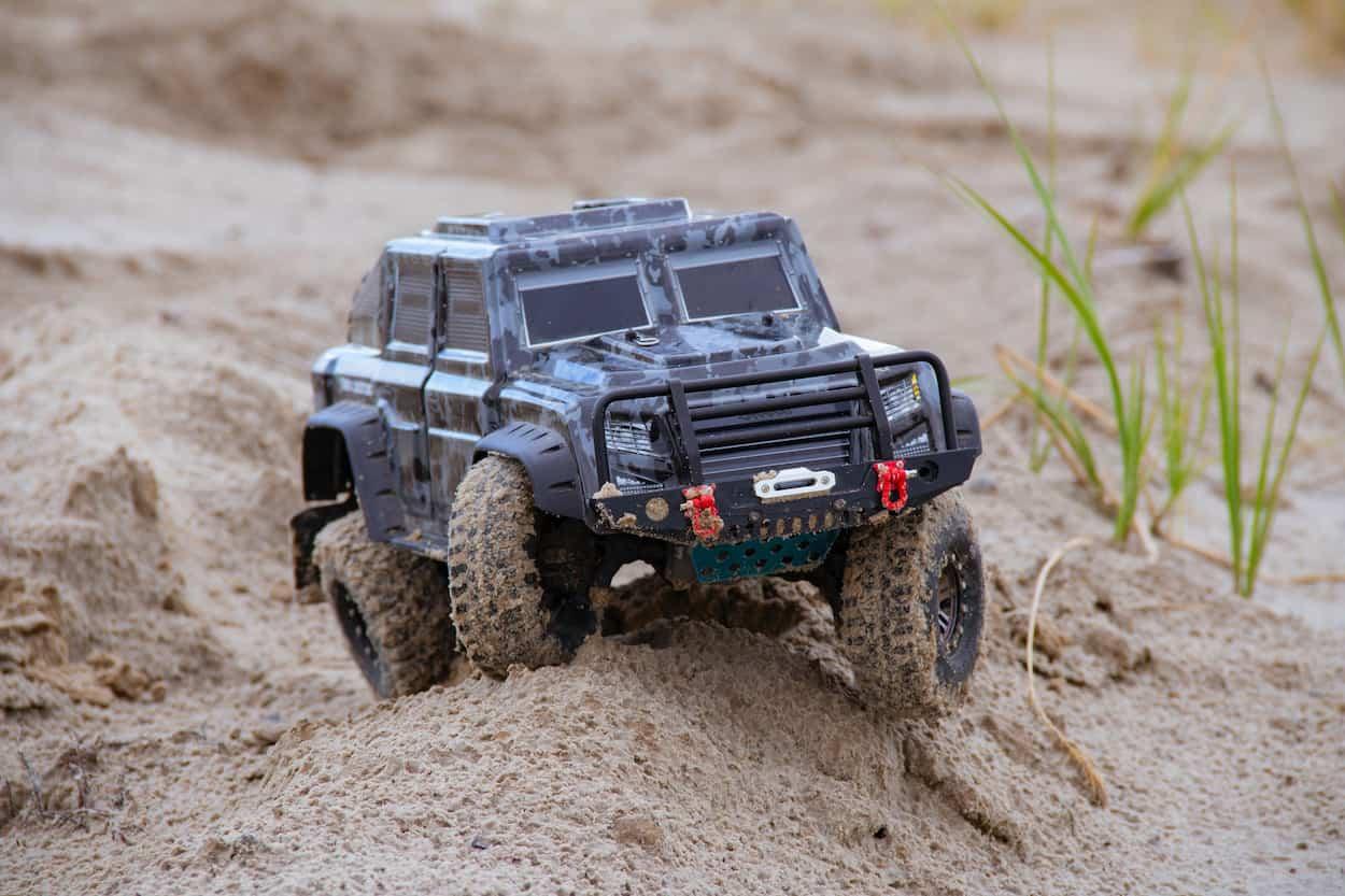 rc crawler jeep on a sandy beach