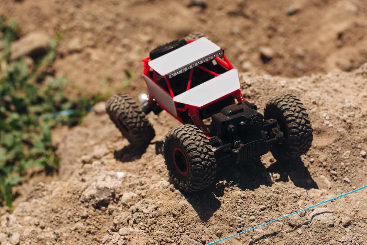 rc crawler driving up a steep rock slope