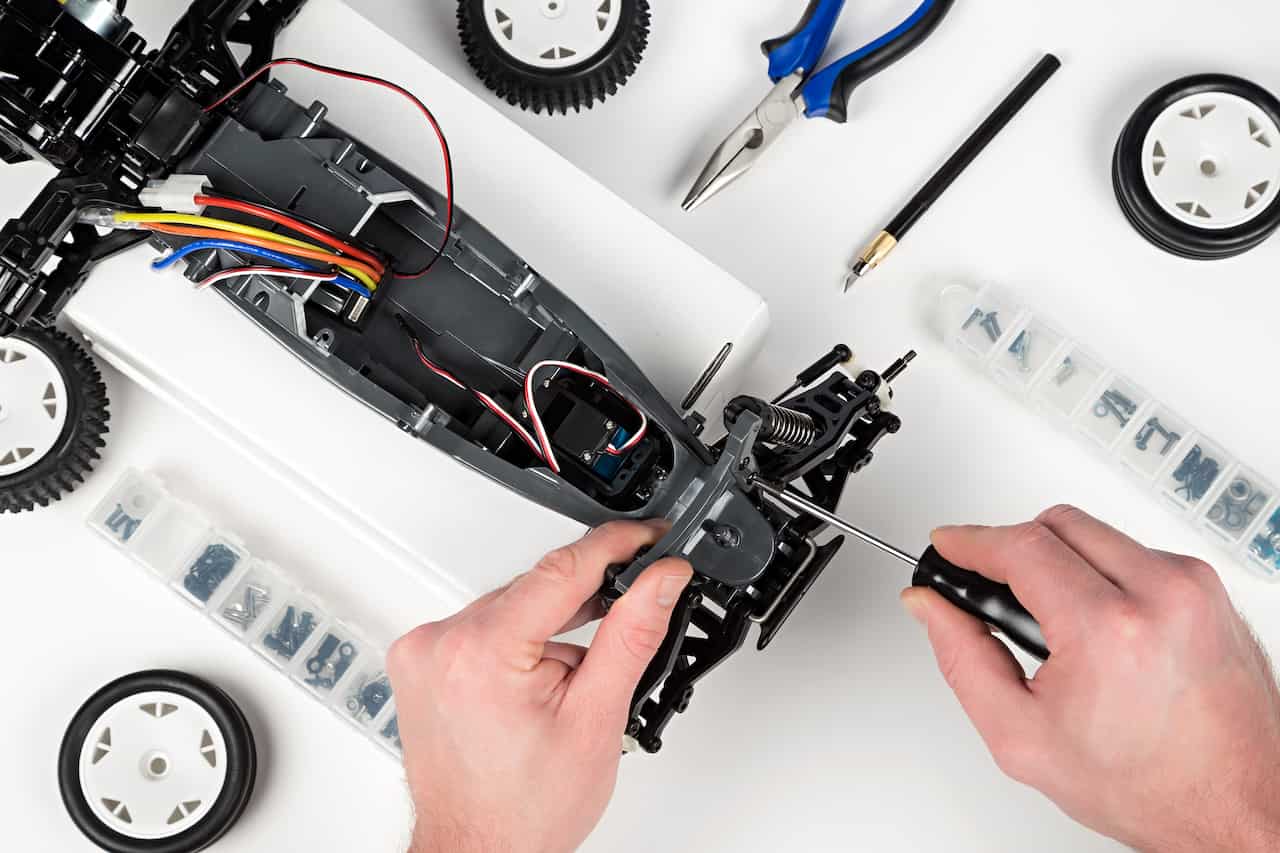 overhead view of hands putting together an rc car from scratch